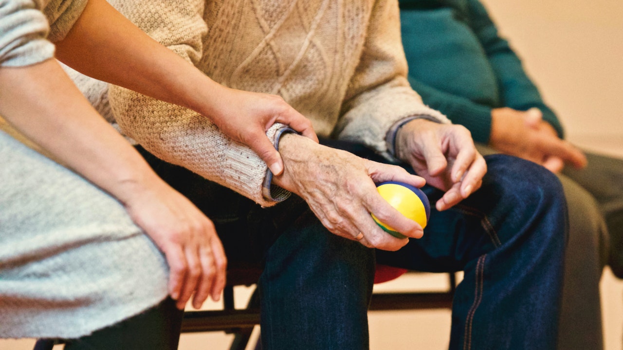 senior holding a ball